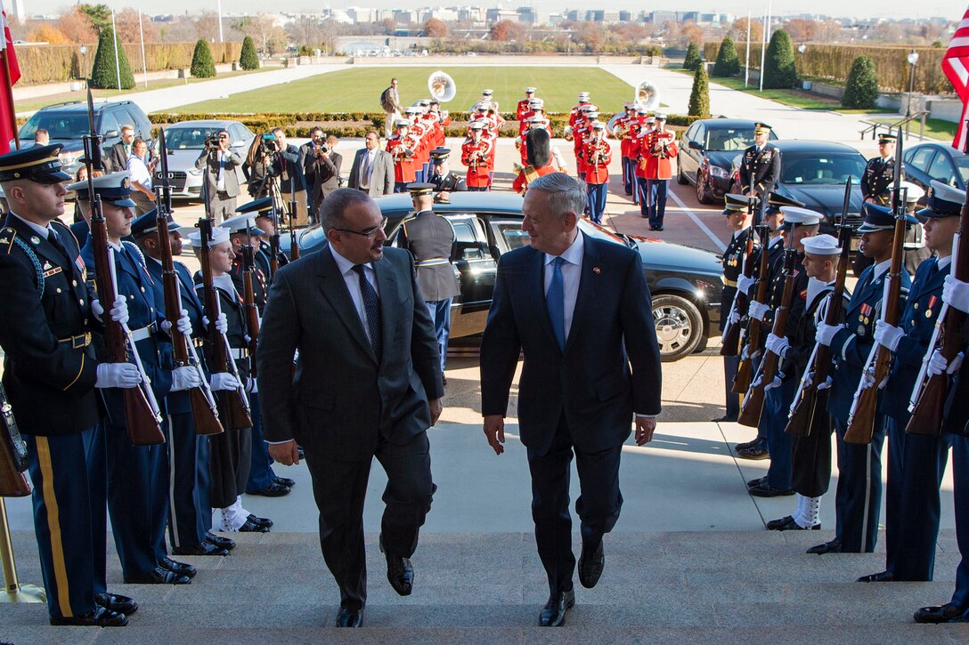Defense Secretary James N. Mattis walks up steps with Bahraini Crown Prince Salman bin Hamad al Khalifa.