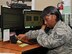 Staff Sgt. Courtney Jackson, 9th Reconnaissance Wing Beale command post senior emergency action controller answers a phone call
