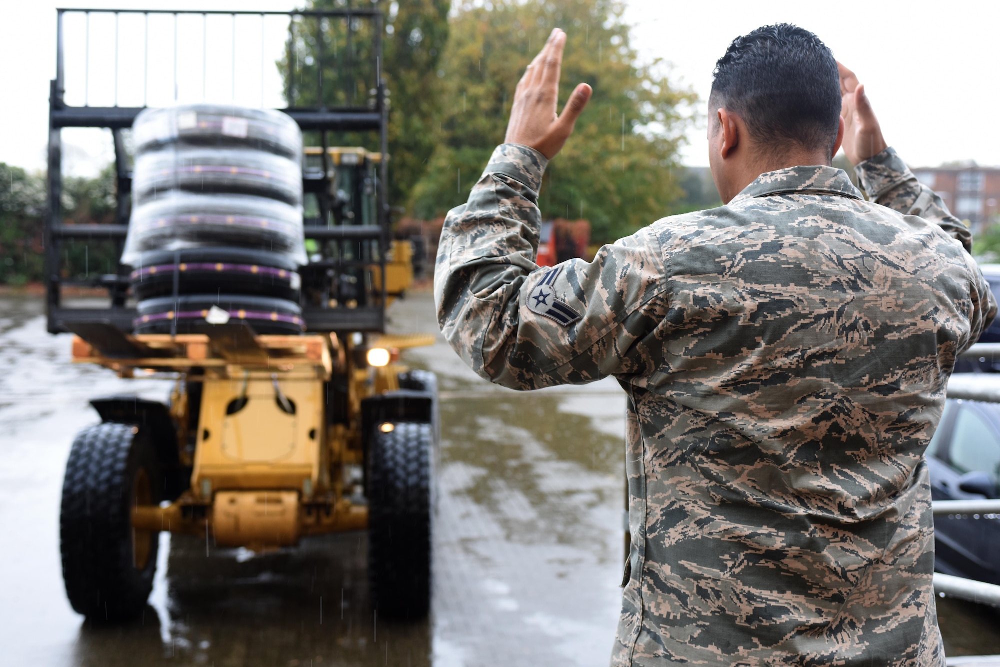 An Airman assigned to the 48th Logistics Readiness Squadron marshals in a forklift at Royal Air Force Lakenheath, England, Oct. 18. The ground transportation element of the 48th LRS is responsible for transporting parts, equipment and Airmen anywhere they are needed. (U.S. Air Force photo/Airman 1st Class Eli Chevalier)