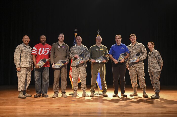 Col. Jimmy Canlas, 437th Airlift Wing commander, far left, and Chief Master Sgt. Jennifer Kersey, 437th AW command chief, far right, stand with the award recipients from the 437th AW Third Quarter Awards Ceremony at the air base theater on Joint Base Charleston, S.C., Oct. 25, 2017.