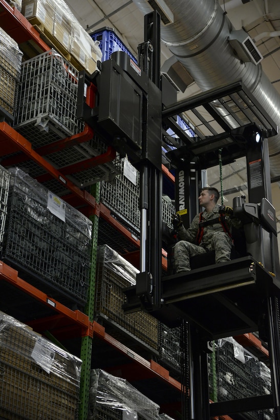 Staff Sgt. Timothy Snyder, 436th Logistics Readiness Squadron materiel management supervisor, retrieves a crate of gas masks from storage during a Civil Reserve Air Fleet readiness exercise Nov. 13, 2017, inside the individual protective equipment warehouse on Dover Air Force Base, Del. The IPE was packed and prepared for transportation as part of the first Civil Reserve Air Fleet IPE transportation exercise. (U.S. Air Force photo by Staff Sgt. Aaron J. Jenne)