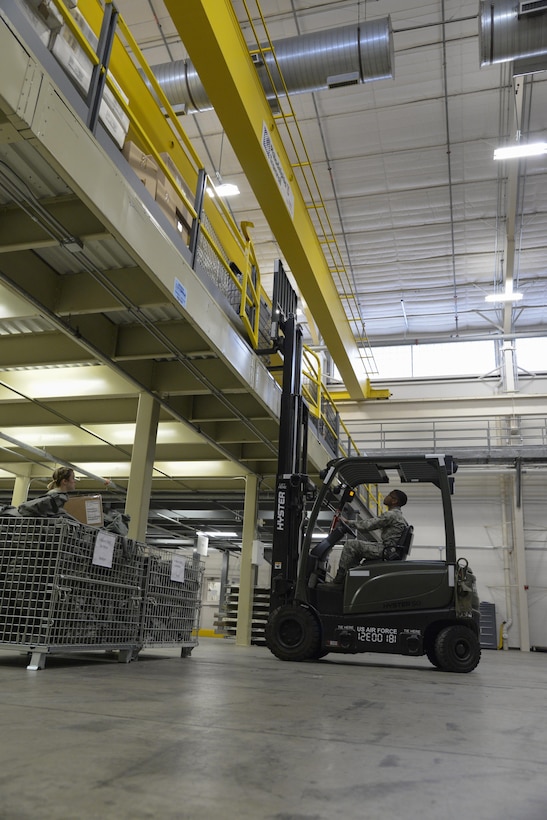 Airman 1st Class Tyric Guess, 436th Logistics Readiness Squadron materiel management technician, moves a container during a Civil Reserve Air Fleet readiness exercise Nov. 13, 2017, inside the individual protective equipment warehouse on Dover Air Force Base, Del. The IPE warehouse stores the base’s protective equipment, which protects individuals from chemical, biological, radiological and nuclear threats. (U.S. Air Force photo by Staff Sgt. Aaron J. Jenne)