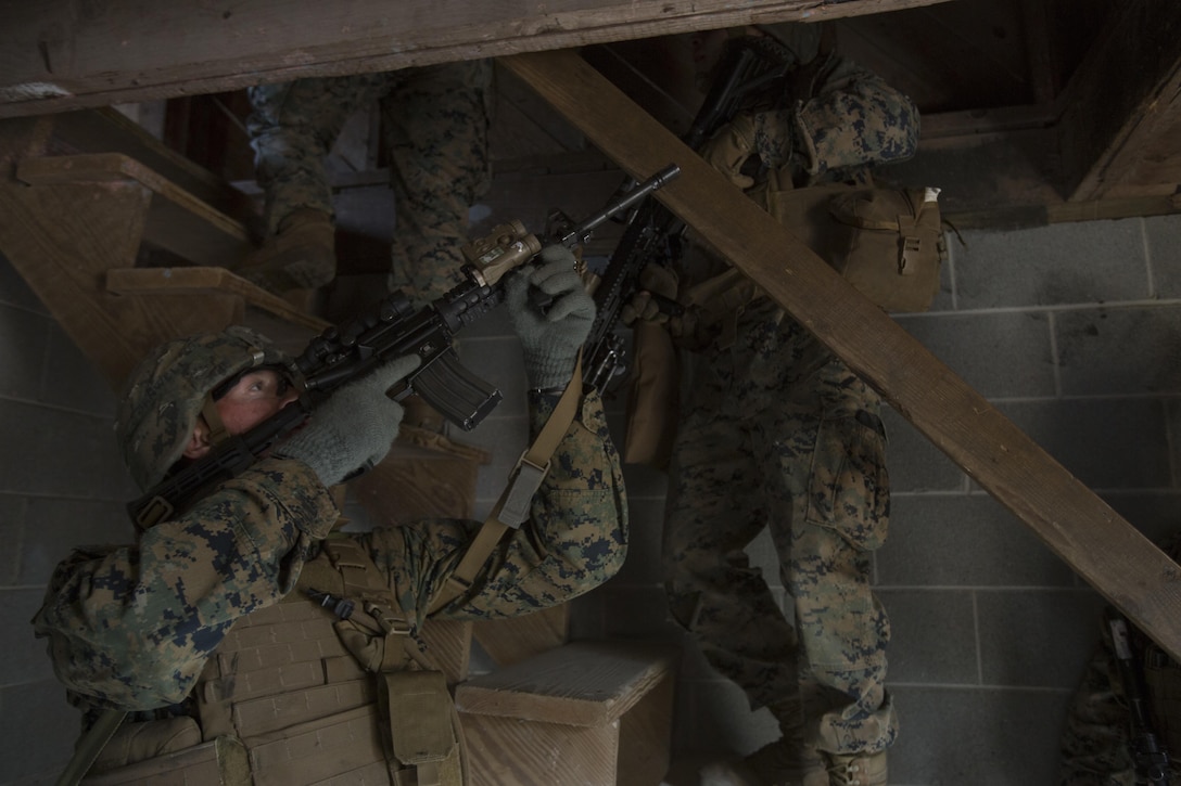 Marines with 1st Battalion, 2nd Marine Regiment begin to clear the second story of a building during a military operations on urbanized terrain exercise at Marine Corps Base Camp Lejeune, N.C., Nov. 21, 2017. The Marines conducted MOUT training to maintain combat readiness. (U.S. Marine Corps photo by Lance Cpl. Ashley McLaughlin)