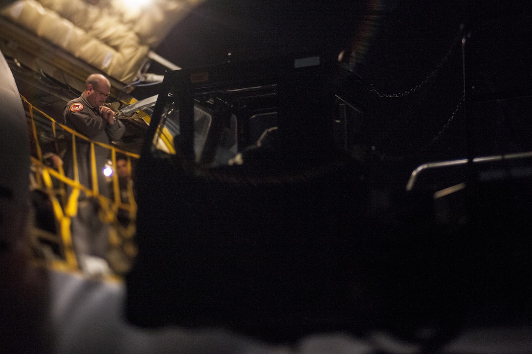 A U.S. Air Force Airman guides a 60K aircraft cargo loader while unloading gear from a KC-135 Stratotanker at Joint Base McGuire-Dix-Lakehurst, N.J., Nov. 21, 2017. This photo was taken with a tilt-shift lens. (U.S. Air National Guard photo by Master Sgt. Matt Hecht)