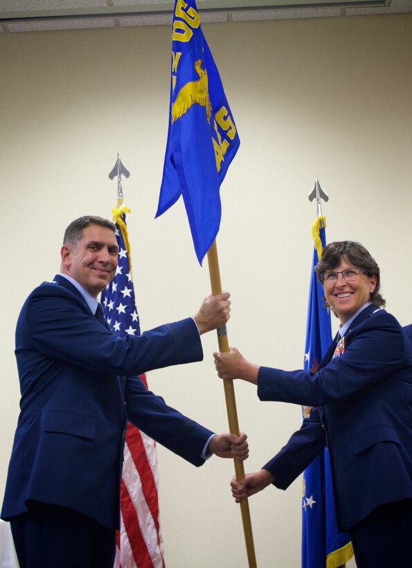 Commander of the 932nd Airlift Wing, Col. Raymond Smith, passes the 932nd Aeromedical Evacuation Squadron flag to the new commander, Lt. Col. Dawn Rice, in a special assumption of command ceremony held Nov. 5, 2017, at Scott Air Force Base, Ill.  (U.S. Air Force photo submitted by Staff Sgt. April White)