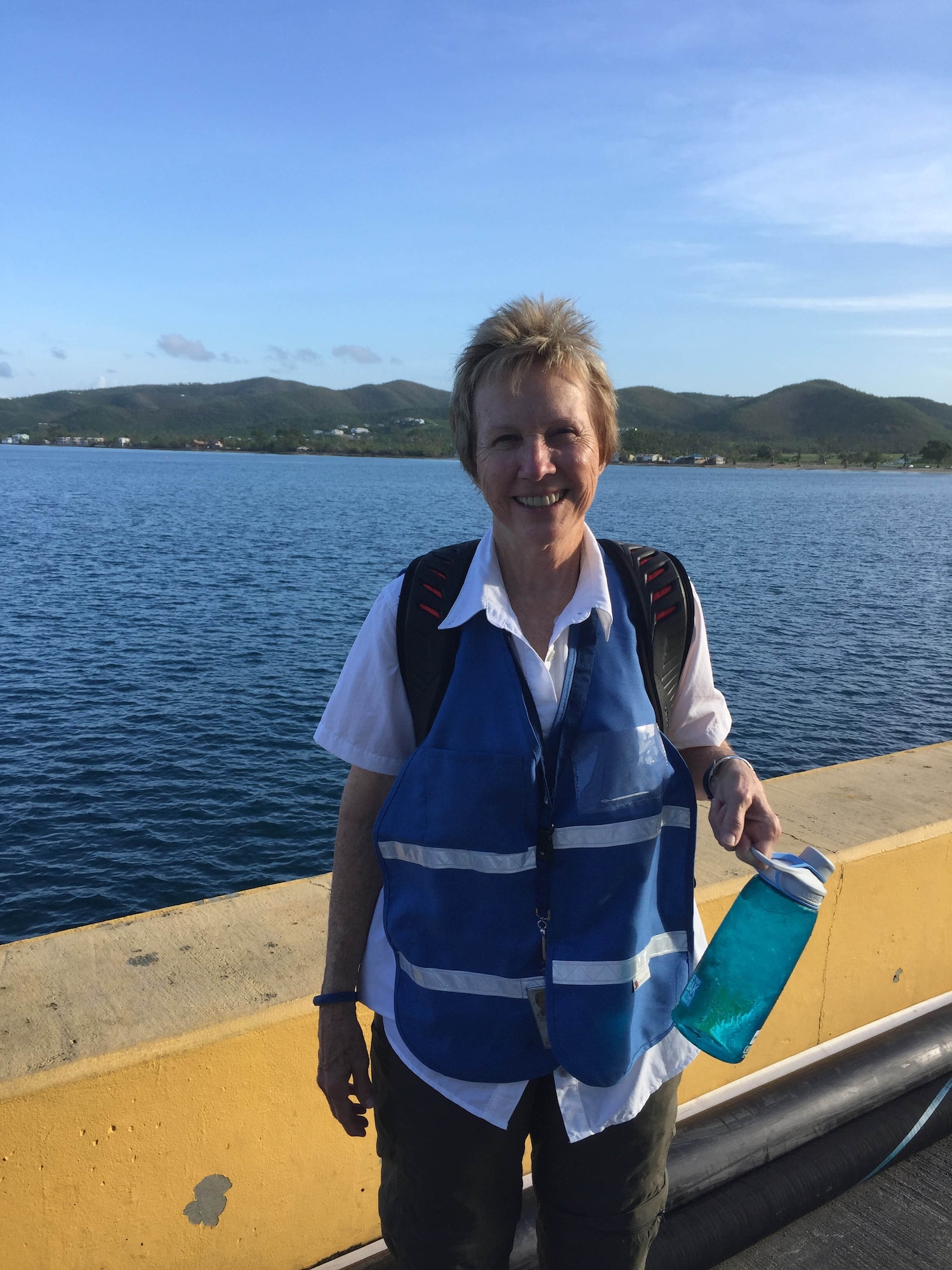 Claudette Wells, an acquisition program manager for the Air Force Technical Applications Center, Patrick AFB, Fla., stands near the dock at Frederiksted, St. Croix as she prepares to head out to work as a Federal Emergency Management Agency disaster relief volunteer.  Wells was part of FEMA's Surge Capacity Force that helped those affected by Hurricane Maria, a Category 5 storm that barreled through the Caribbean in September 2017.  (Courtesy photo)