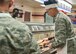 Col. Richard Gibbs, 377th Air Base Wing commander, serves a Thanksgiving meal to an Airman Nov. 24. Several commanders and command chiefs took a shift serving meals at the dining facility on Thanksgiving to show their appreciation to all Airmen, retirees, and their families.