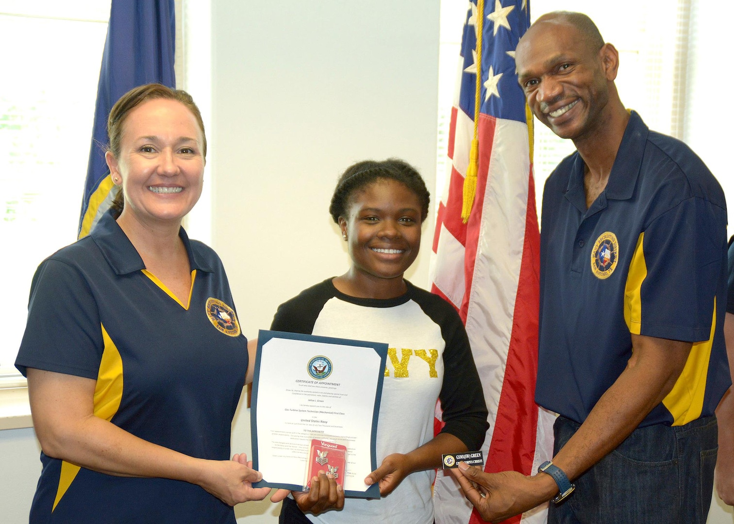 Cmdr. Karen Muntean and Command Master Chief Eric Mays of Navy Recruiting District San Antonio stand with Petty Officer 1st Class Jalisa Green, a recruiter assigned to Navy Recruiting Station Corpus Christi, who was advanced in rank through the Navy's Meritorious Advancement Program.