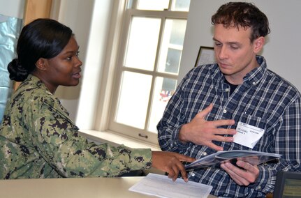 Petty Officer 1st Class Jalisa Green, a recruiter assigned to Navy Recruiting Station Corpus Christi, Navy Recruiting District San Antonio, speaks with future Sailor Oleksandr Omelchemko regarding his career choice at the Military Entrance Processing Station.