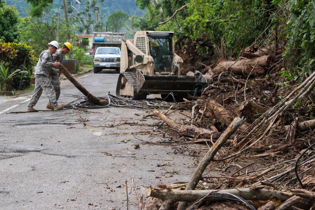 Guard help clear roads in Puerto Rico.