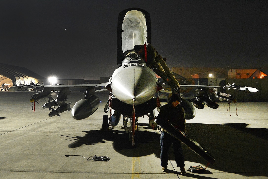 Airmen prepare an F-16 fighting falcon for takeoff.