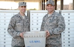 Lt. Col. Hart (left), commander, 802nd Force Support Squadron, and Lt. Col. Robert G. Giovannetti (right), 502nd Communications Squadron, pose outside the student mail center at Joint Base San Antonio-Fort Sam Houston Nov. 27 after JBSA postal operations transferred to the direction of the 802d FSS. They had been a part of the 502nd Communications Squadron since 1993 and will be realigned under the 802nd FSS.
