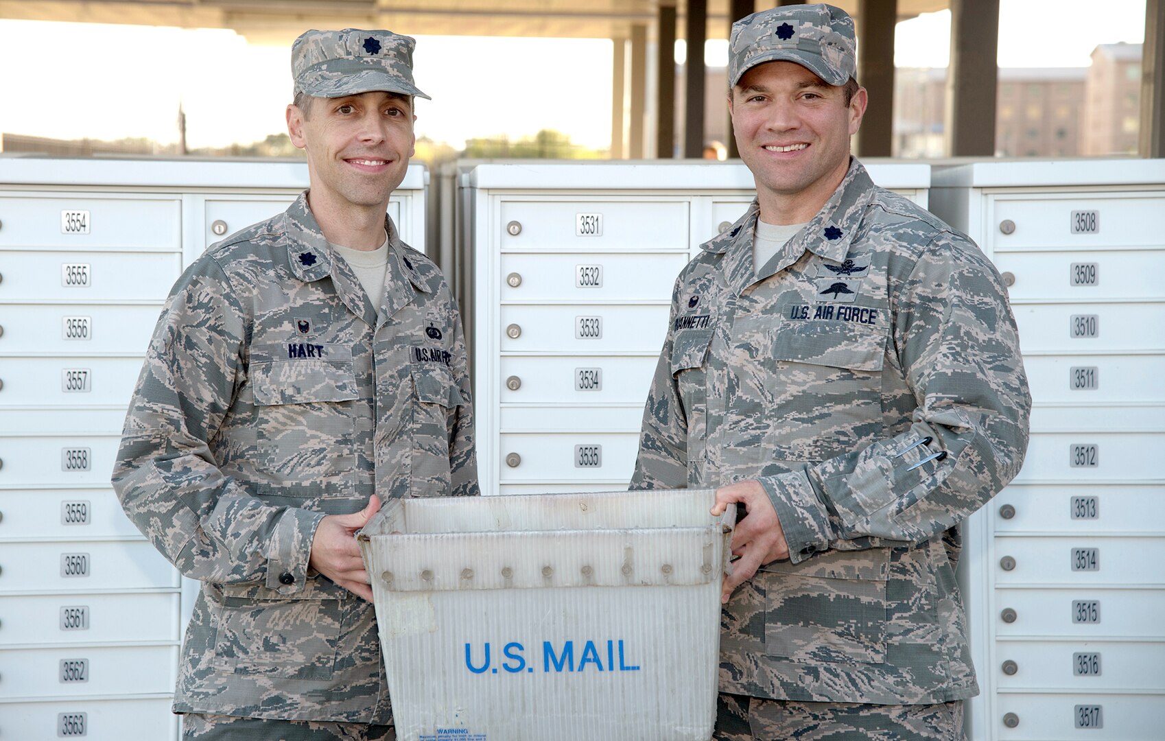 Lt. Col. Hart (left), commander, 802nd Force Support Squadron, and Lt. Col. Robert G. Giovannetti (right), 502nd Communications Squadron, pose outside the student mail center at Joint Base San Antonio-Fort Sam Houston Nov. 27 after JBSA postal operations transferred to the direction of the 802d FSS. They had been a part of the 502nd Communications Squadron since 1993 and will be realigned under the 802nd FSS.