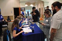 IMAGE: Members of Naval Surface Warfare Center Dahlgren Division’s Human Resources team check-in potential employees during the 2017 Winter Job Fair at the Fredericksburg Expo and Conference Center, Nov. 28.