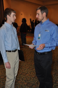 IMAGE: A representative from Naval Surface Warfare Center Dahlgren Division speaks with a potential employee during the 2017 Winter Job Fair at the Fredericksburg Expo and Conference Center, Nov. 28.