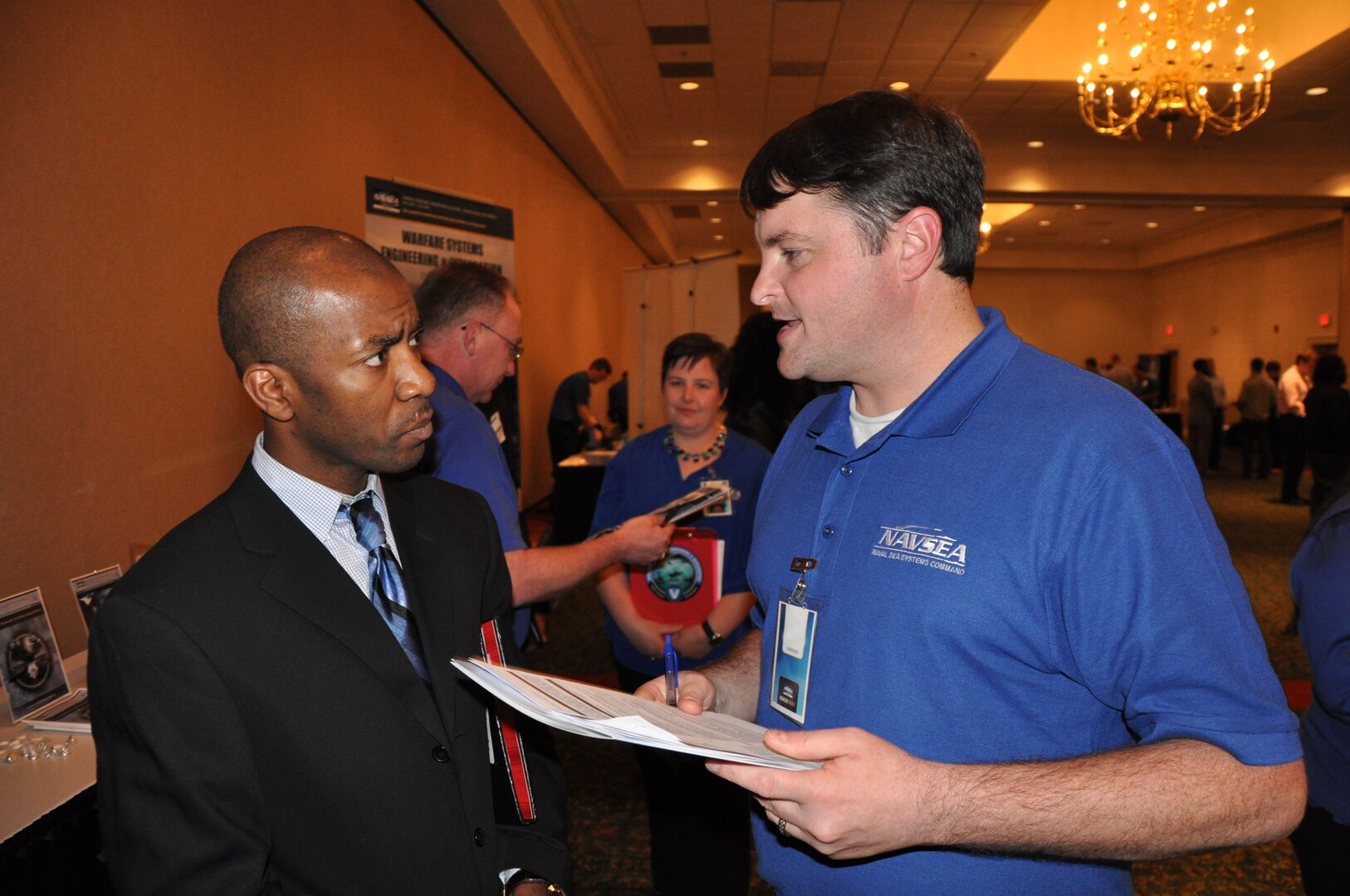 IMAGE: A representative from Naval Surface Warfare Center Dahlgren Division speaks with a potential employee during the 2017 Winter Job Fair at the Fredericksburg Expo and Conference Center, Nov. 28.
