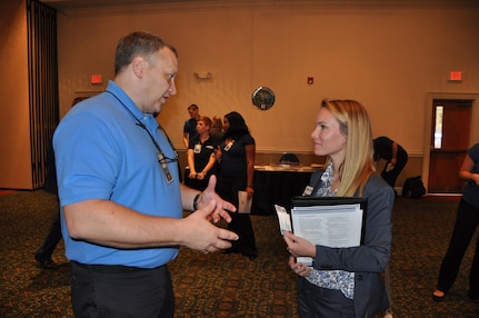 IMAGE: A representative from Naval Surface Warfare Center Dahlgren Division speaks with a potential employee during the 2017 Winter Job Fair at the Fredericksburg Expo and Conference Center, Nov. 28.