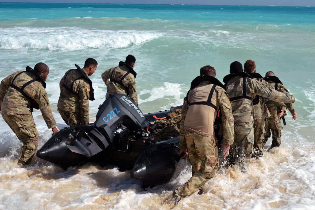 Soldiers carry craft during training.