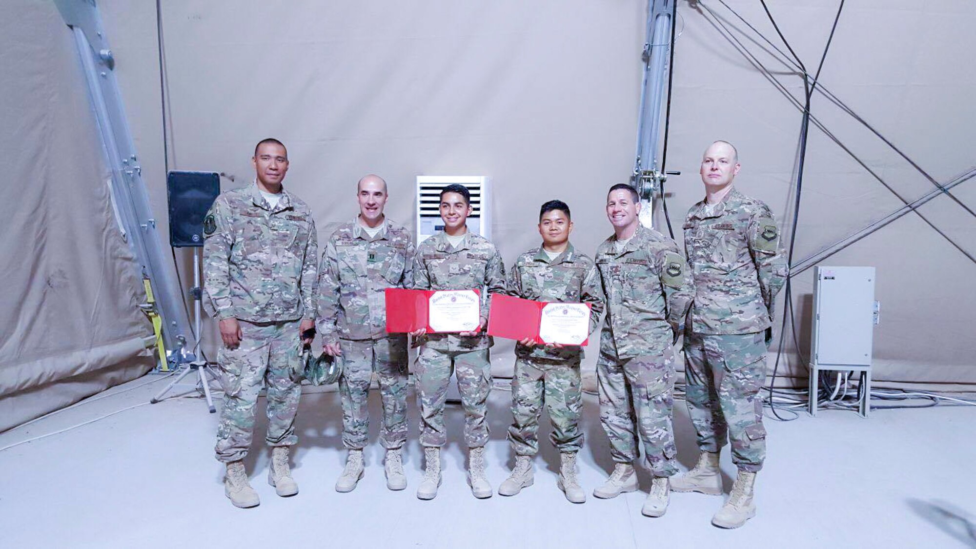 Senior Airman Nicoli Martin Leuterio, 366th Logistics Readiness Squadron material management journeyman, poses for a photo with his leadership during his deployment to Southwest Asia.