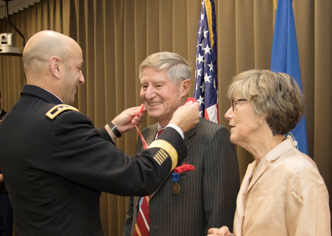 Dr. James Hearn, with wife Lauren is presented the the Bronze DeFluery Medal by Northwestern Division Commander, Maj. Gen. Scott A. Spellmon. Dr. Hearn retires after more then 30 years of federal service including the last 8 years with the Northwestern Division.