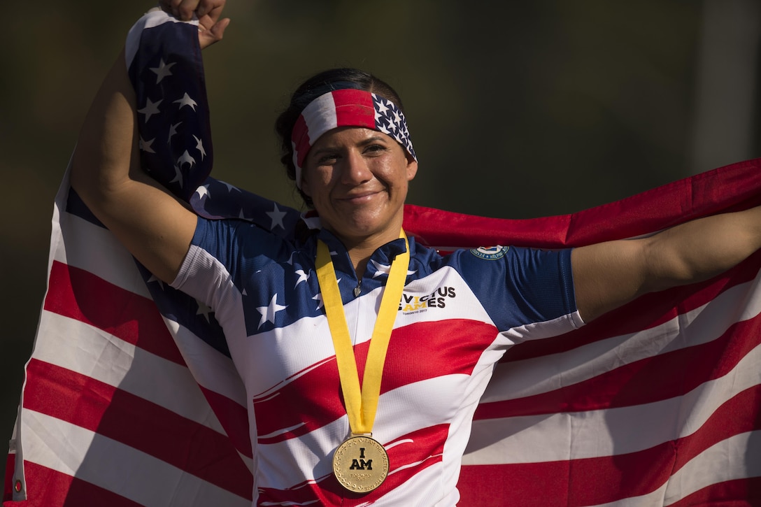 Medically retired Air Force Staff Sgt. Sebastiana Lopez-Arellano reacts to winning a gold medal for hand cycling during the 2017 Invictus Games in Toronto, Sept. 26, 2017. DoD photo by EJ Hersom