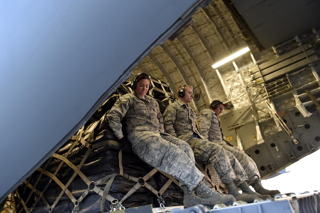 Aerial porters load cargo onto a C-17 Globemaster III aircraft in preparation for Hurricane Maria relief efforts, Sep. 30, 2017, at Travis Air Force Base, Calf. The aircraft from March Air Reserve Base, Calif., will deliver a 65-member Contingency Response Element to Aguadilla, Puerto Rico to establish command and control of the airfield and provide aerial port and maintenance support during Hurricane Maria relief efforts.  (U.S. Air Force photo by Tech. Sgt. Liliana Moreno/Released)