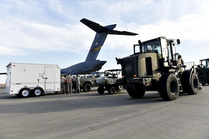 Airmen load cargo onto a C-17 Globemaster III aircraft in preparation for Hurricane Maria relief efforts, at Travis Air Force Base, Calf., Sept. 30. The aircraft from March Air Reserve Base, Calif., will deliver a 65-member Contingency Response Element to Aguadilla, Puerto Rico to establish command and control of the airfield and provide aerial port and maintenance support during Hurricane Maria relief efforts.  (U.S. Air Force photo by Tech. Sgt. Liliana Moreno/Released)