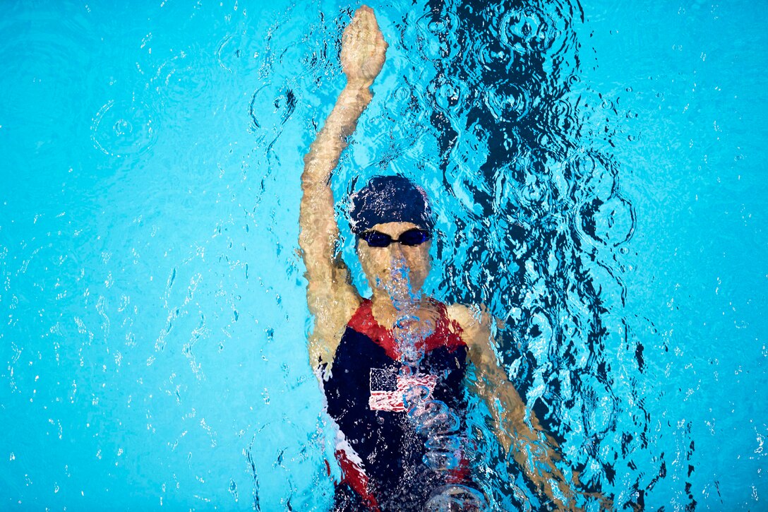 An airman pushes off the block in a backstroke race.
