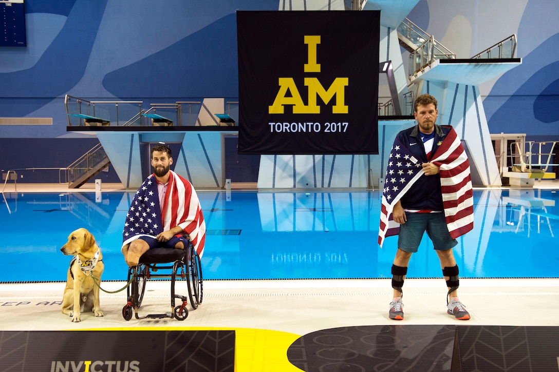 Two Team U.S. members face forward after receiving medals.