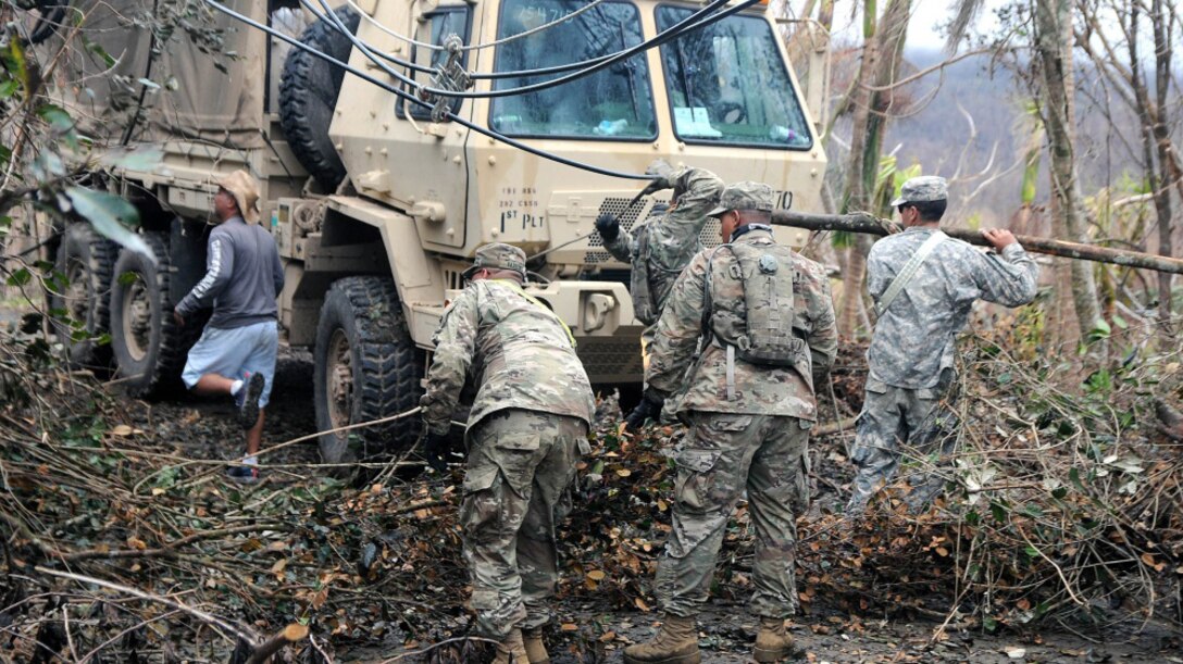 Soldiers clear debris.
