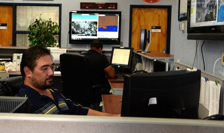Mark Savelio, 81st Operations Support Flight weather forecaster, and Nicky Brown, 81st OSF weather technician, look at weather patterns at base operations Sept. 18, 2017, on Keesler Air Force Base, Mississippi. The weather office tracks weather patterns and provides weather briefings for all aircraft missions, which helps aircrews avoid potentially dangerous situations. The 81st OSF is responsible for all air operations. (U.S. Air Force photo by Airman 1st Class Suzanna Plotnikov)