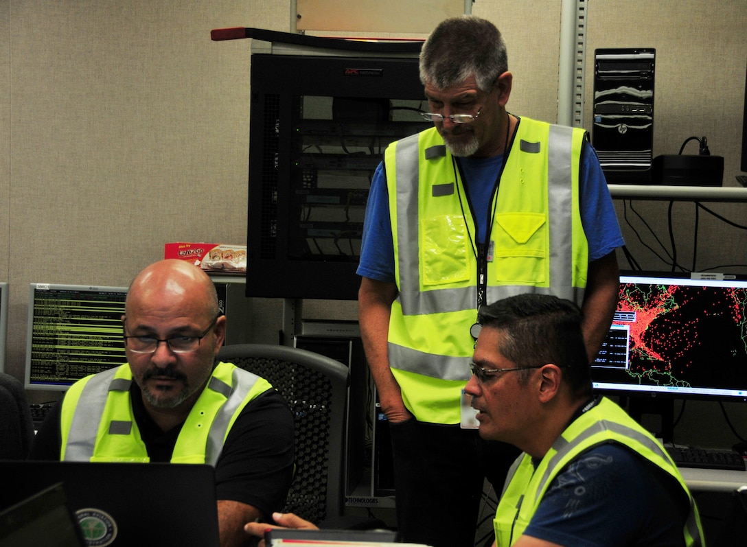 Operations manager Edward Tirado (right) communicates with members of the emergency operations center team at the FAA's Puerto Rico Operations Center, Sept. 30, 2017. The partnership between the FAA and the Puerto Rico Air National Guard was instrumental in restoring air traffic operations.  (U.S. Air National Guard Photo by Capt. Matt Murphy)