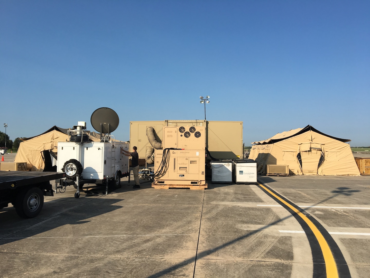 Robert Garcia is inspecting the communications gear at the FEMA Incident Support Base at Randolph Air Force Base.