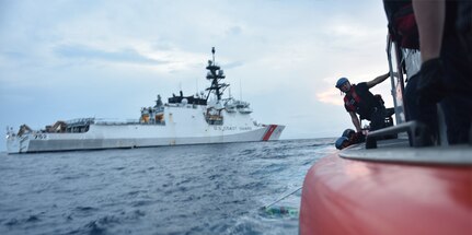 Coast Guard personnel recover jettisoned cocaine bales out of the Pacific Ocean