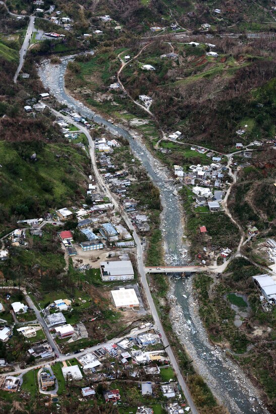 Army pilots fly their HH-60M Black Hawk helicopter over several cities devastated by Hurricane Maria.