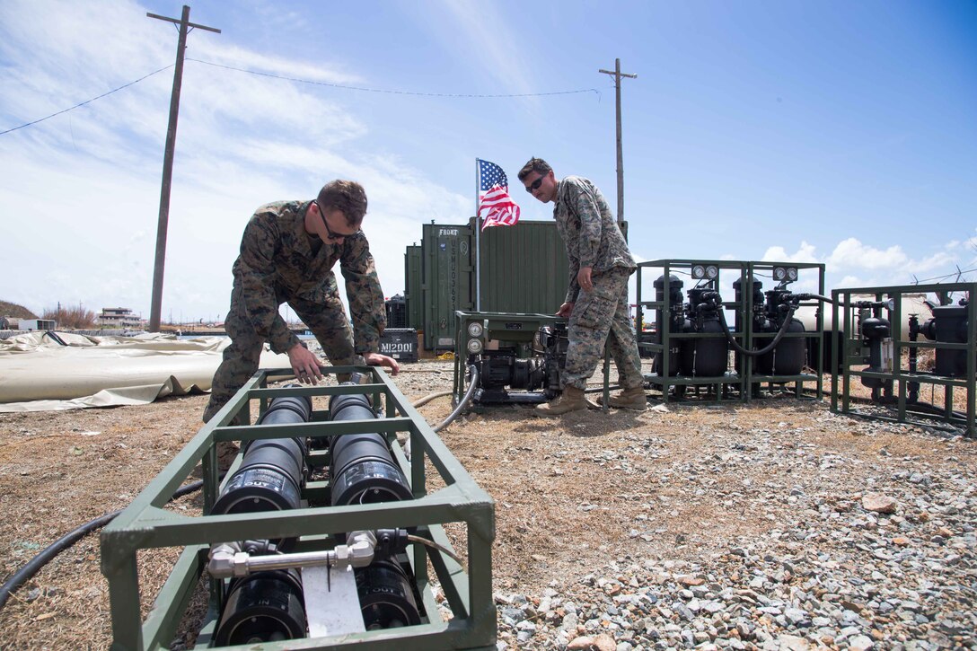 U.S. Marine Corps Cpl. Brendan Gorvett, left, and Sgt. Eric Garcia, both water support technicians with Combat Logistics Battalion 26, 26th Marine Expeditionary Unit (MEU), pull the anchors on a water purification system in support of Hurricane Maria relief efforts at Ceiba, Puerto Rico, Sept. 29, 2017. The 26th MEU is supporting Federal Emergency Management Agency, the lead federal agency, in helping those affected by Hurricane Maria to minimize suffering and is one component of the overall whole-of-government response effort. (U.S. Marine Corps photo by Lance Cpl. Alexis C. Schneider)