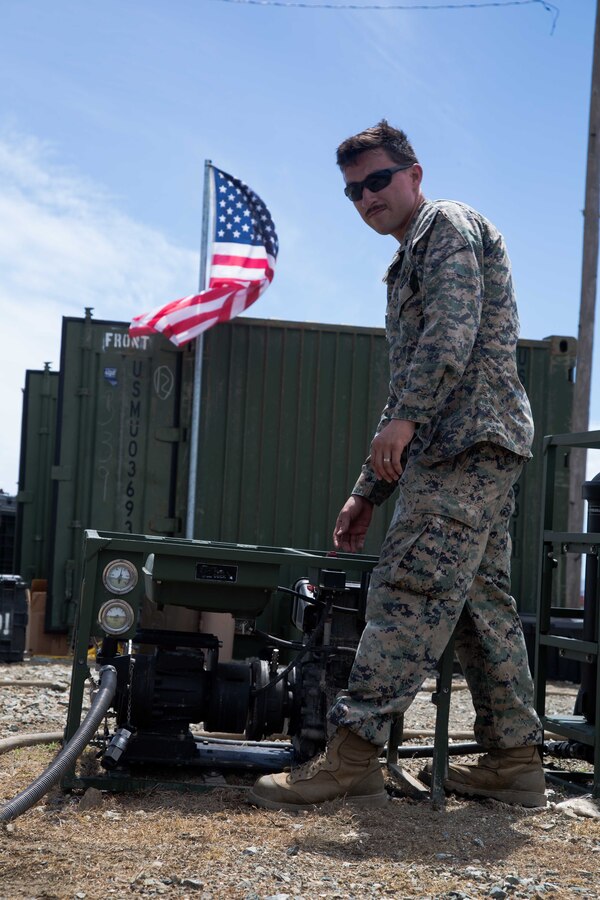 U.S. Marine Corps Sgt. Eric Garcia, a water support technician with Combat Logistics Battalion 26, 26th Marine Expeditionary Unit (MEU), pulls the anchor on a water purification system in support of Hurricane Maria relief efforts at Ceiba, Puerto Rico, Sept. 29, 2017. The 26th MEU is supporting Federal Emergency Management Agency, the lead federal agency, in helping those affected by Hurricane Maria to minimize suffering and is one component of the overall whole-of-government response effort. (U.S. Marine Corps photo by Lance Cpl. Alexis C. Schneider)