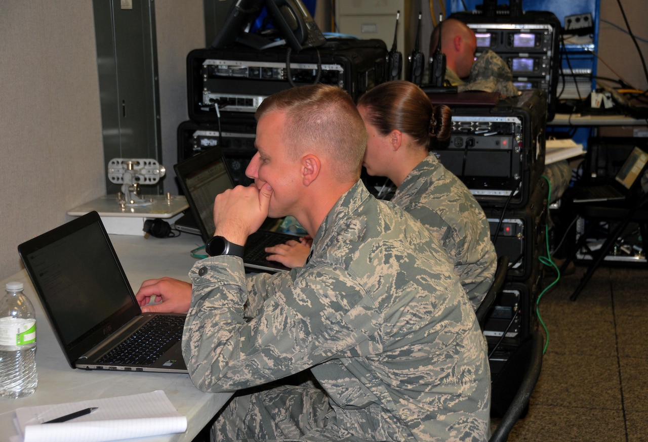 Capt. Jeff Rutkowski from the 115th Fighter Wing, Wisconsin Air National Guard, and members of his team work inside the Puerto Rico FAA Operations Center, Sept. 30, 2017. The Wisconsin Guardsmen established a JISCC to restore air traffic communications allowing the FAA to resume full operations. (U.S. Air National Guard Photo by Capt. Matt Murphy)