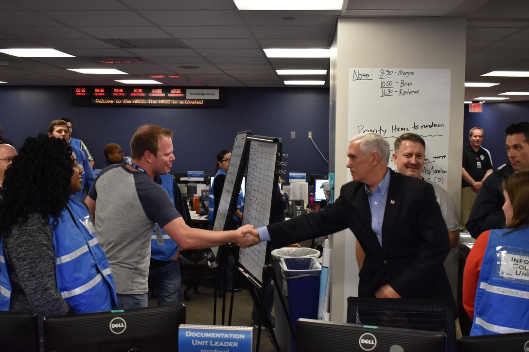 The vice president shakes hands with a person.