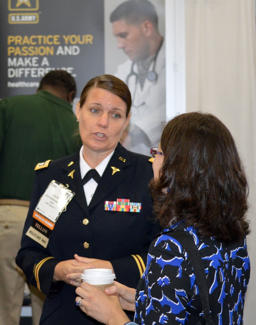 Army Lt. Col. Julie Hundertmark, Army Medical Corps recruiting integration officer with the Medical Recruiting Brigade at Fort Knox, Ky., speaks with a woman at the American Academy of Family Physicians Family Medicine Experience 2017 or FMX 2017, Sept. 14 at the Henry B. Gonzales Convention Center in downtown San Antonio. Hundertmark was one of two subject matter experts supporting San Antonio Medical Recruiting Center recruiters manning the Army Medicine display during the conference.