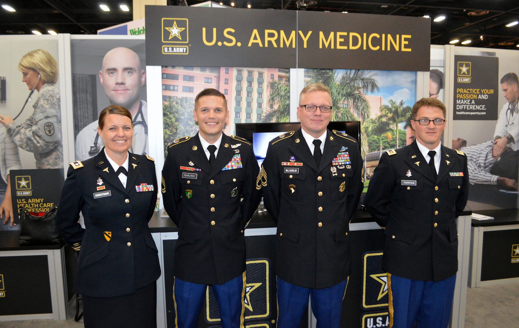 (From left) Army Lt. Col. Julie Hundertmark, Army Medical Corps recruiting integration officer with the Medical Recruiting Brigade at Fort Knox, Ky., Army Sgts. 1st Class Colin Rawlings and Chad McLaughlin, of the San Antonio Medical Recruiting Center, and Army Maj. Timothy Thompson, an active duty family medicine physician and teaching faculty member at the Martin Army Community Hospital Family Medicine Residency Program in Fort Benning, Ga., pose in front of the Army exhibit at the American Academy of Family Physicians Family Medicine Experience 2017 or FMX 2017, Sept. 14 at the Henry B. Gonzales Convention Center in downtown San Antonio.