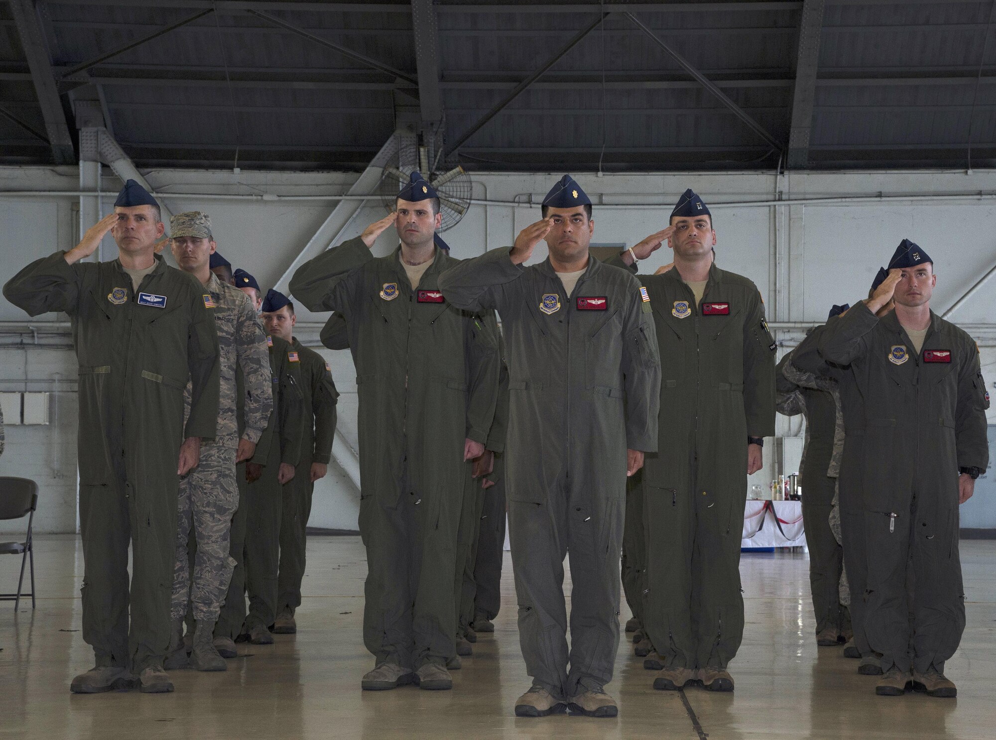 U.S. Air Force Airmen salute during the singing of the National Anthem at the 50th Air Refueling Squadron (ARS) assumption of command ceremony at MacDill Air Force Base, Fla., Oct. 2, 2017.