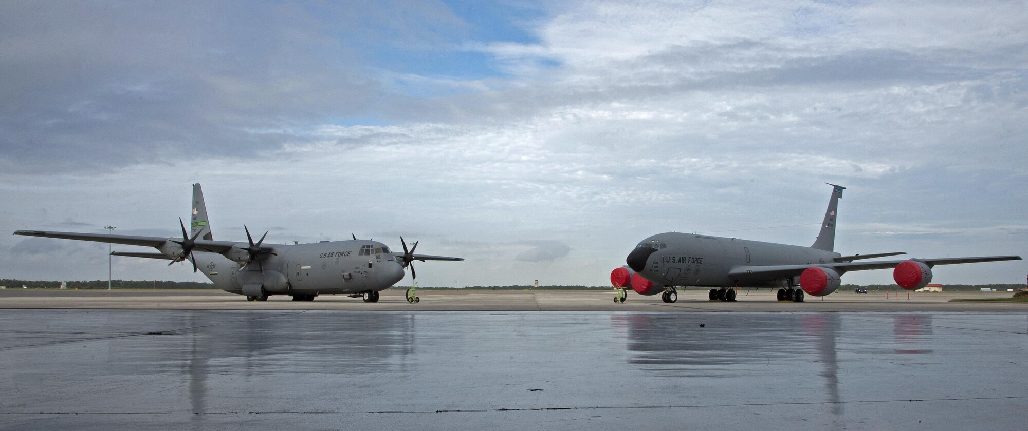 A C-130 Hercules aircraft and a KC-135 Stratotanker aircraft sit on the flightline during an assumption of command ceremony for the 50th Air Refueling Squadron (ARS) at MacDill Air Force Base, Fla., Oct. 2, 2017.