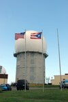 The U.S. and Puerto Rico flags flap in a stiff breeze in front of the radar tower operated by 140th Air Defense Support Squadron in Aguadilla,