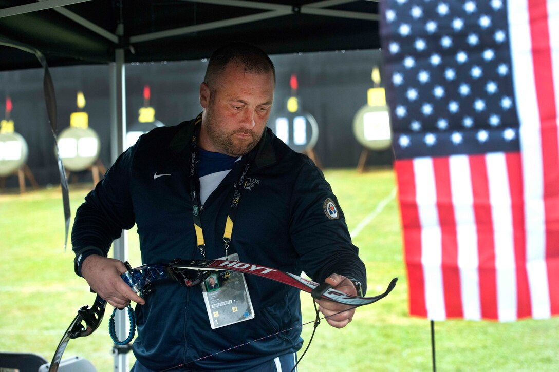 Sgt. Sean Hook strings his bow before competing in archery during the 2017 Invictus Games.