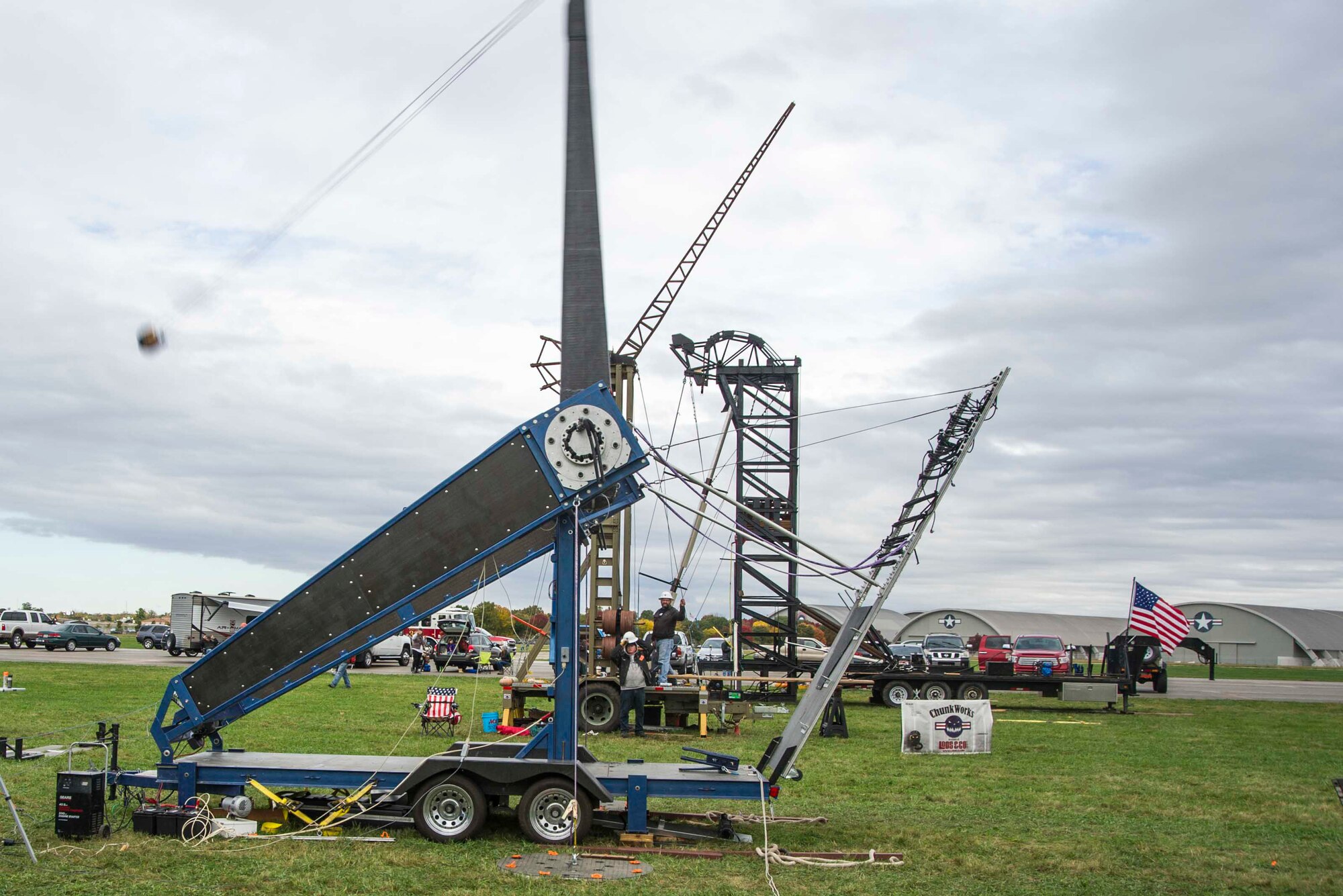 Team ETHOS’ The Phoenix machine (foreground) launches a 10-pound pumpkin downrange at the 12th Annual Pumpkin Chuck, Oct. 21, 2016 behind the National Museum of the United States Air Force at Wright-Patterson Air Force Base, Ohio. The Phoenix is an experimental torsion hybrid which uses the torque of twisted ropes for its throwing power. (U.S. Air Force photo/R.J. Oriez)