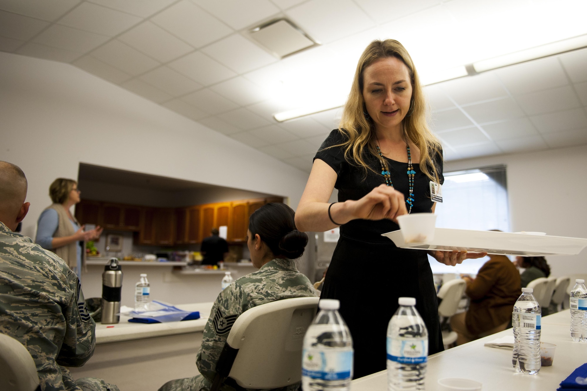 Karina Kislitsyna, San Angelo Community Medical Center chef assistant, hands out food to visitors during a food demonstration at the Taylor Chapel on Goodfellow Air Force Base, Texas, Sept. 26, 2017. The food was prepared and cooked by Marc Daniels, San Angelo Community Medical Center executive chef. (U.S. Air Force photo by Senior Airman Scott Jackson)