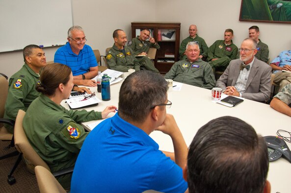 WRIGHT-PATTERSON AIR FORCE BASE, Ohio – Aeromedical Consultation Service Deputy Chief Dr. Daniel Van Syoc (left in blue) oversees a case review session with flight surgeons and other medical professionals, some of which are the world experts in their fields. The ACS has screened new pilots and made waiver recommendations for existing air crews since the early 1950s. (U.S. Air Force photo/John Harrington)