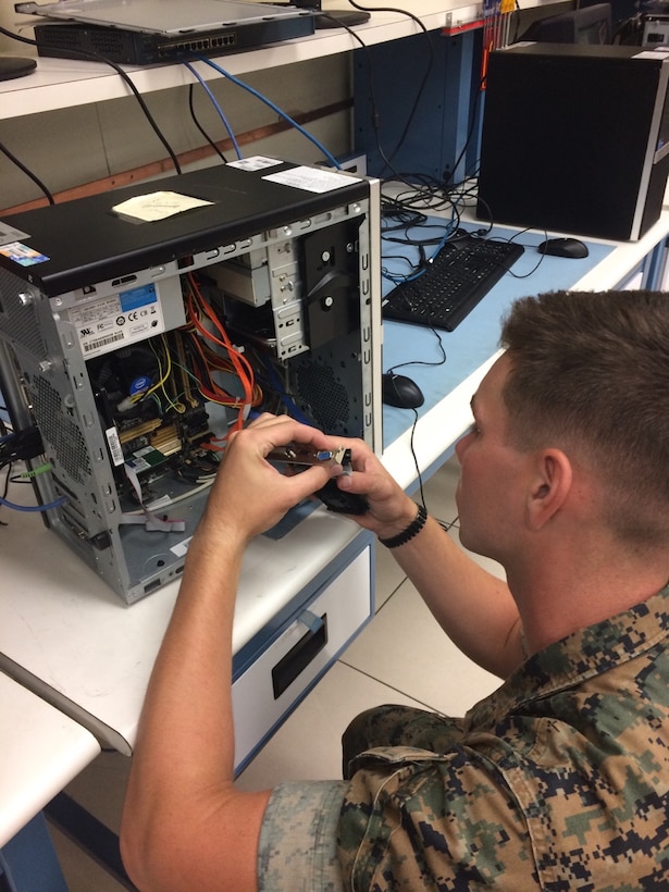 Private First Class Ethan T. Wampler is seen here trouble shooting a video card in the Data System Annex.  This is part of the training Marines receive within the Telephone System Computer System Repair Course as they identify broken component and execute the appropriate repairs. Private First Class Wamper will attain the MOS 2847 and greatly enhance the capabilities of his unit.