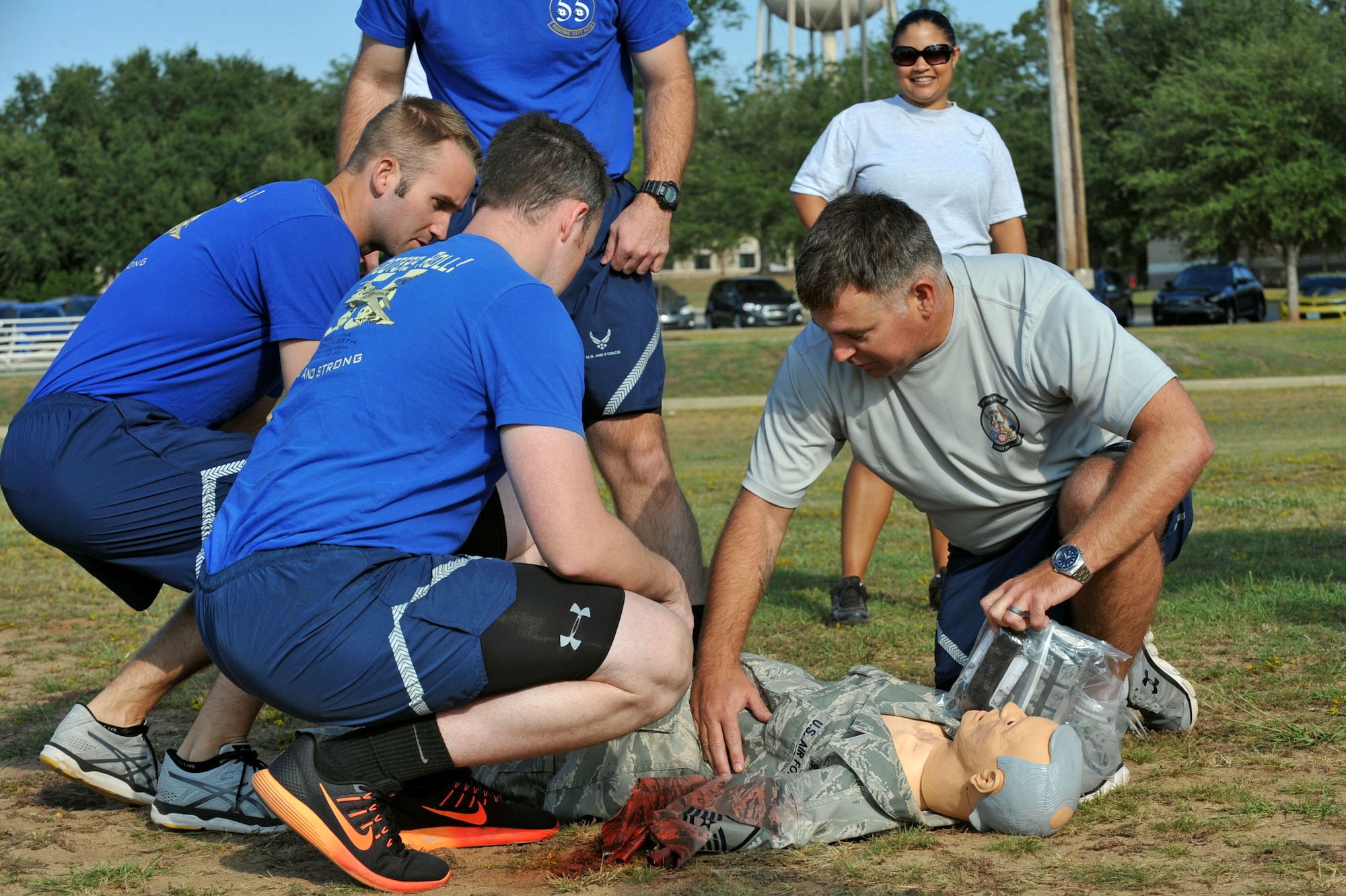 U.S. Airmen assigned to the 20th Operations Group test their self-aid buddy care knowledge on a mannequin during a Warrior Day commander’s challenge at Shaw Air Force Base, S.C., Sept. 29, 2017.